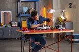 Person interacting with LEGO DeLorean.