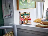 LEGO 40696 Bakery model displayed on a windowsill with home decor.