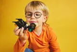Child holding the Batmobile.