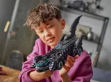Child holding Batmobile model.