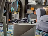 Batmobile displayed in a room.