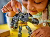 Child inserting minifigure into mech.