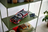 Batmobile on a green shelf.