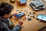 Overhead view of child building Batmobile.