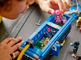 Placing minifigure in bus.