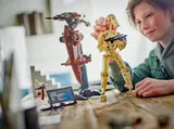 Child posing LEGO Battle Droid.