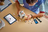 Child building BB-8 with tablet.