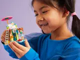 Child holding built set.