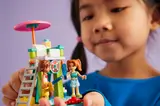 Child holding set, minifigs in focus.