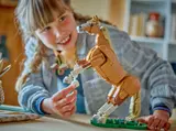 Child interacts with rearing LEGO horse.