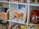LEGO deer model on bookshelf.