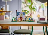 Girl playing with open LEGO Friends house.