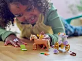 Child playing with Belle riding horse.