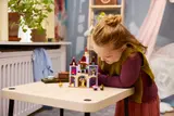 Child examining LEGO castle.