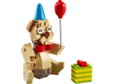 A brick-built bear with a party hat, balloon, and gift.
