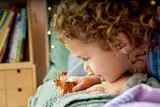 Child playing with Woody and Bullseye.