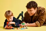 Father and son playing with LEGO Bluey.