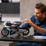 Man interacting with LEGO Technic BMW.
