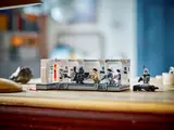 Wider shot of boy playing with LEGO Tantive IV diorama on a table.