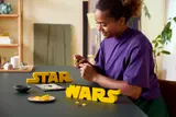 Person holding Star Wars logo
