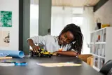Child playing with LEGO Technic Bugatti Bolide.