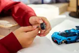 Child attaching Bugatti wheel.