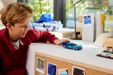 Child playing with Bugatti Vision GT.