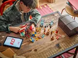 Child building LEGO One Piece Buggy's Circus Tent set.