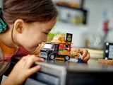 Child playing with LEGO Burger Truck.