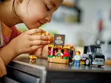 Child playing with detached LEGO burger stand.