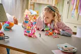 Child smiling while playing with LEGO.