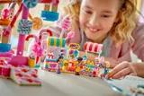 Child playing at LEGO fair stalls.