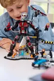 Child playing with Ant-Man figure.