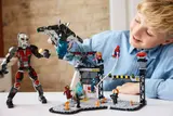 Child holds LEGO Quinjet above battle.