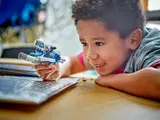 Child playing with Y-Wing Microfighter.