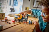 Child playing with LEGO cement mixer.