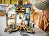 Child's hand placing LEGO pigeons.