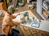 Child building with digital LEGO instructions.