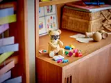 Studious LEGO bear with glasses and book.