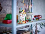 Decorated LEGO Christmas house on a shelf.
