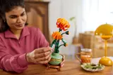 Person adjusting LEGO chrysanthemum.