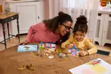 Adult and child building LEGO castle.