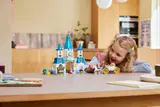 Girl playing with the castle and carriage.