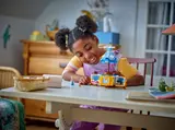 Child playing with Cinderella's dress set.