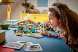 Child admiring completed LEGO streetcar set.