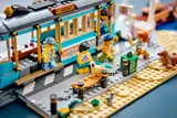Close-up of LEGO streetcar station with minifigures and dog.