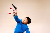 Child 'flying' the mech.