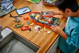 Child building LEGO Coast Guard set.