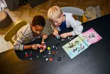 Kids building LEGO Mech.