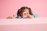 Child playing with LEGO set.